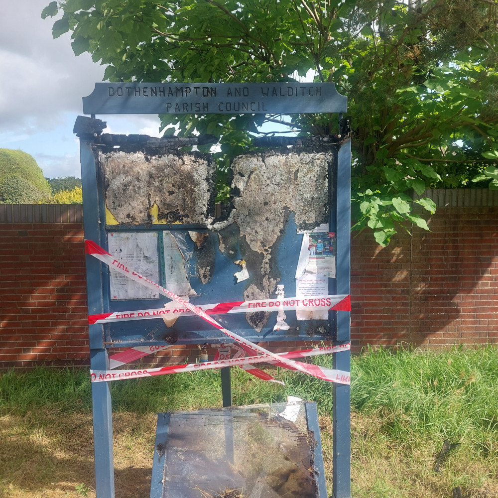 The burnt parish council noticeboard in Pasture Way