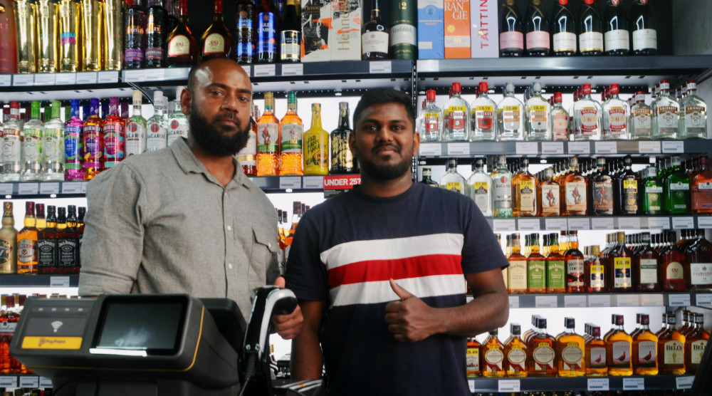 Mihiran and staff member behind counter of newly-opened Premier store in Hadleigh (Picture: Nub News)