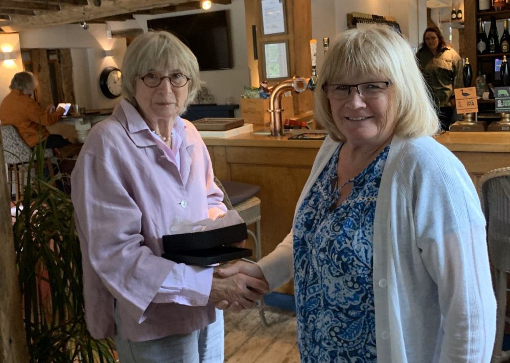 Anna Devey presents Maryjana Bainbridge with her Community Award recently (image supplied)