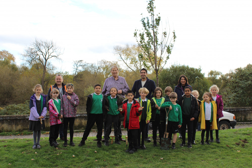 Cllr Salman Shaheen and children from Green Dragon School plant flowers in Watermans Park (credit: Hounslow Council).