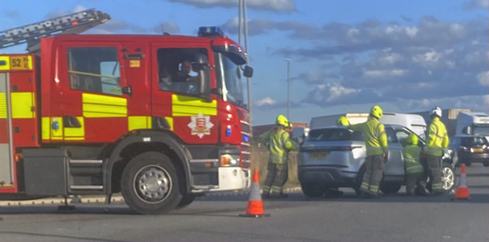 Firefighters attempt to move one of the vehicles.