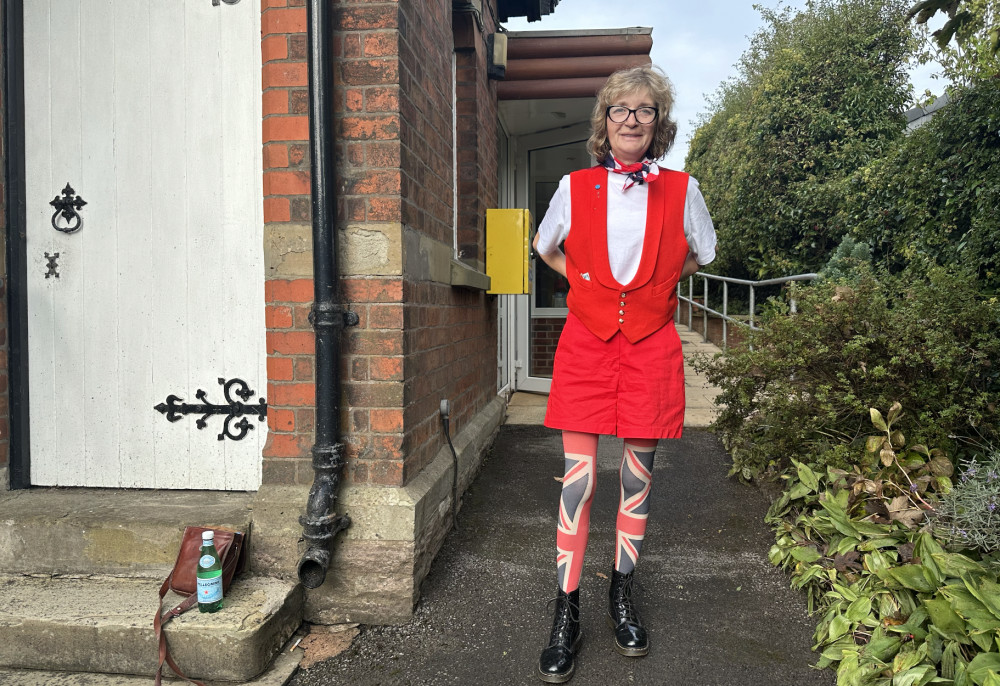 Event Organiser Carole Ann Poole raised close to £500 herself, by donning some Union Jacked-themed tights, whilst conducting the raffle. (Image - Alexander Greensmith / Macclesfield Nub News) 