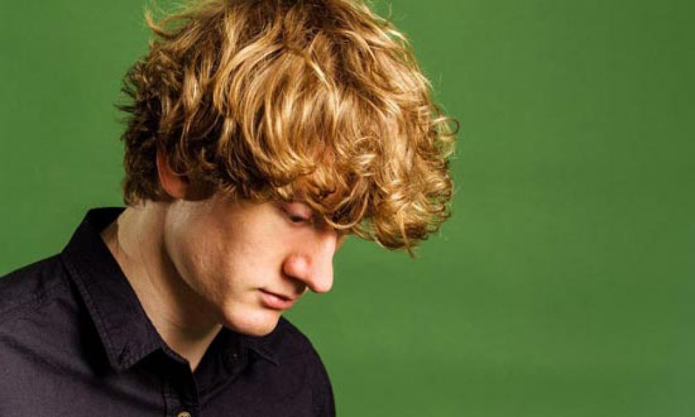 Comedian James Acaster, set to headline the Wells Comedy Festival 2024, encourages audiences to engage in his show 'Hecklers Welcome.'