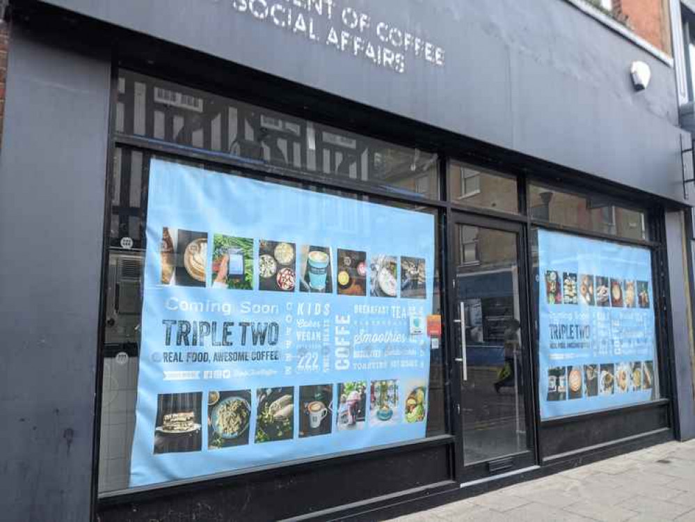 A photo of the former Department of Coffee and Social Affairs site with a banner advertising Triple Two Coffee A photo of the former Department of Coffee and Social Affairs site with a banner advertising Triple Two Coffee