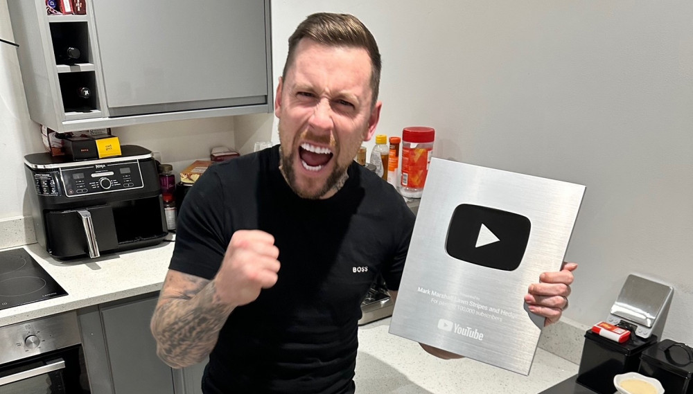 Mark celebrates receipt of the silver play button. (Image - Macclesfield Nub News) 