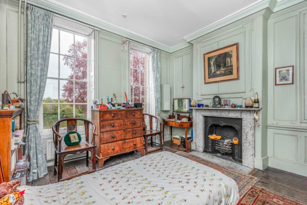 Another bedroom with a beautiful fireplace. (Photo Credit: Savills).