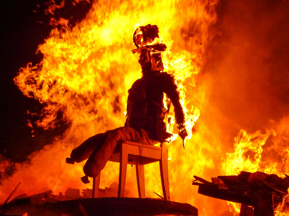 Guy Fawkes ablaze on top of the Queens Park bonfire, lit at 6:30pm (Jonathan White).