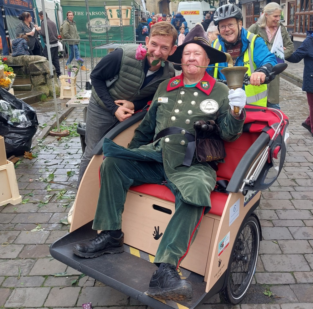 Wells Town Crier Len Sweales and market trader Mick celebrating his first ride in WCN’s trishaw. 