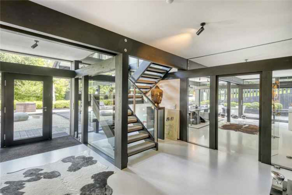 Floating stairs lead up to the first floor and the second kitchen/dining room