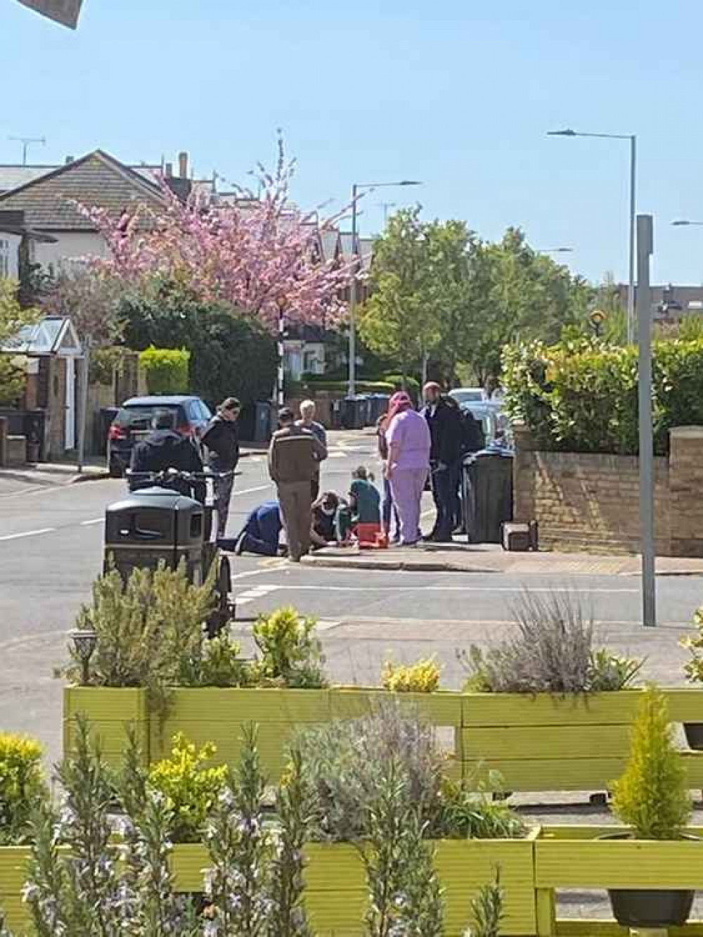 A Kingston vet rescues the stranded baby duck as a crowd of people watch / Credit: Claire Bristow