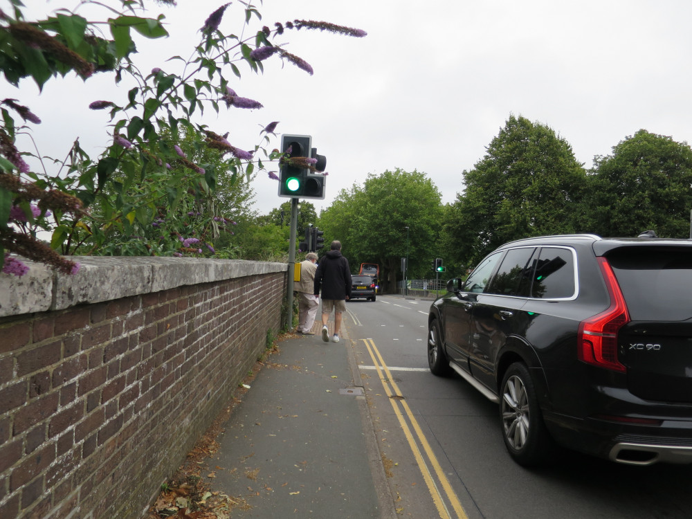 The existing crossing with narrow pavement on the Weymouth Avenue rail bridge