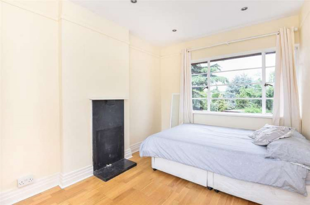 The master bedroom complete with 1930s fireplace and windows! (Photo: Gibson Lane)