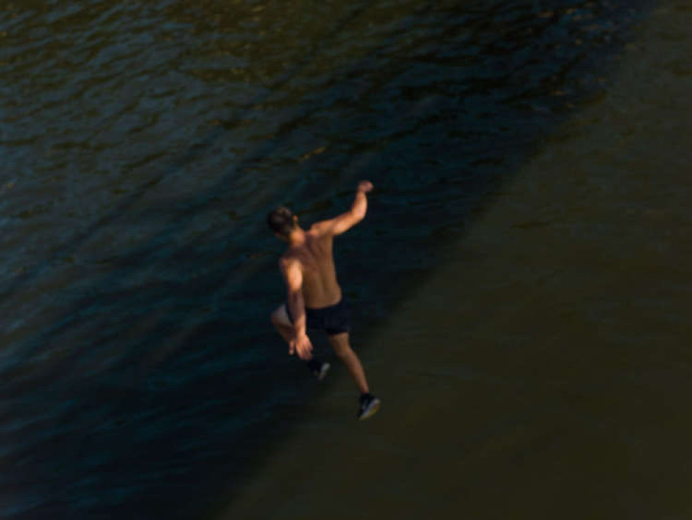 A person jumps off Teddington Lock during the heatwave on Saturday (Photo credit: Ollie Monk)