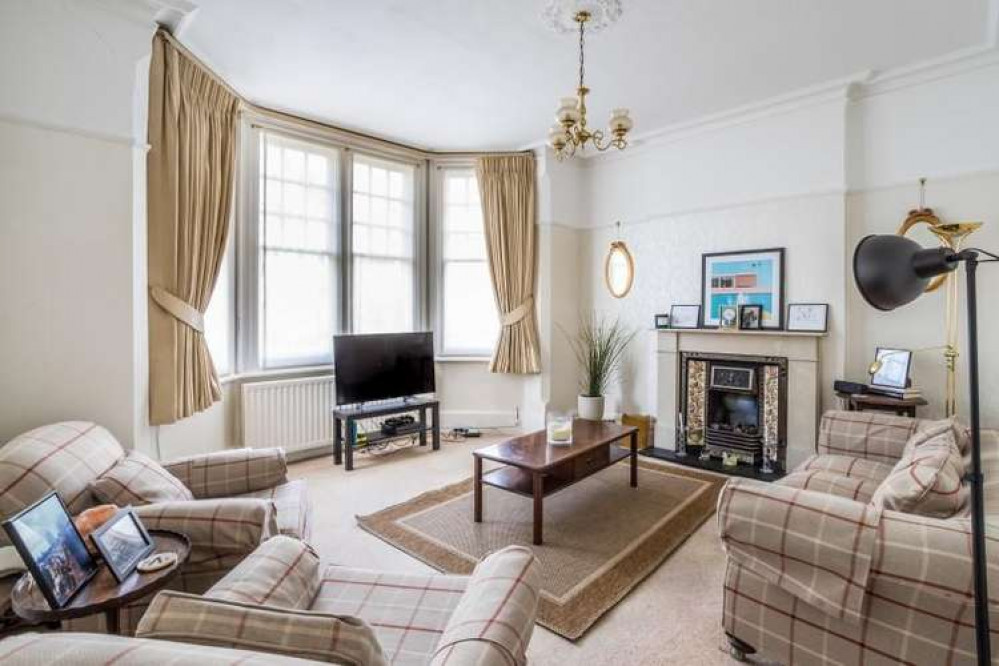 The living room has plenty of period features including a Victorian fireplace (Credit: Carringtons)