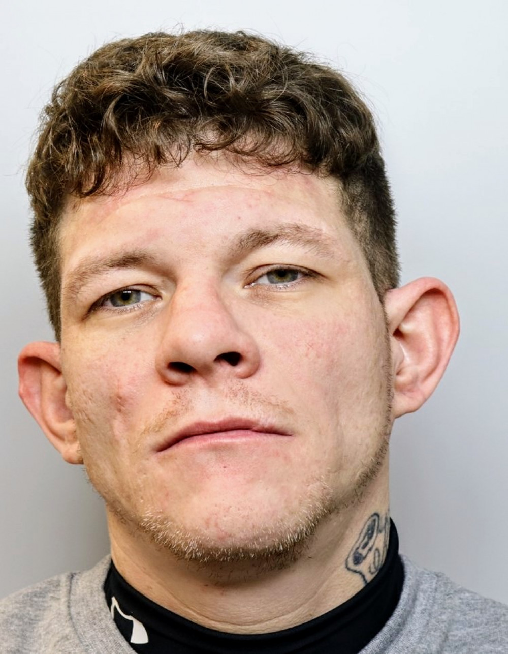 Lewis Spink, 32, from Crewe, is wanted in connection to the breach of a magistrates' court order (Cheshire Police).