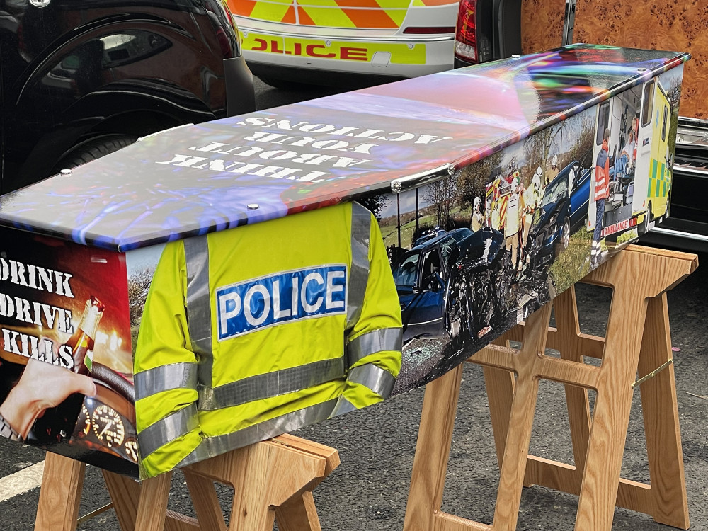 Police officers warned of the dangers of drink or drug driving with coffins wrapped in images of crashed vehicle (image via LDRS)