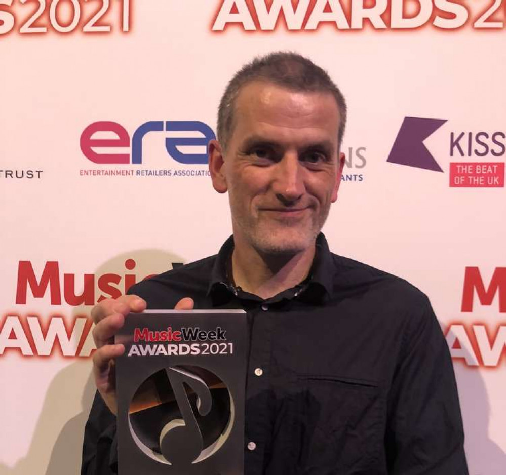 Independent Kingston record shop Banquet Records is run by Jon Tolley - pictured here with the award (Image: Banquet Records)