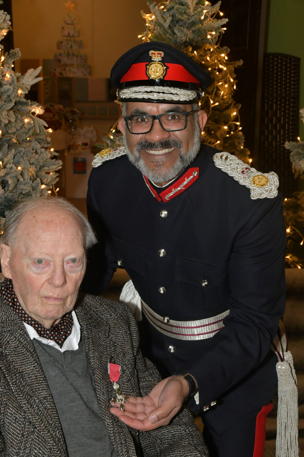 John Bishton receiving his MBE from the Lord-Lieutenant of Somerset, Mohammed Saddiq.