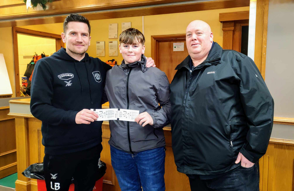 Crewe Alex manager Lee Bell, handing over the free Barrow tickets to Stephen Sugarman and his son Lewis (Ryan Parker). Crewe Alex manager Lee Bell, handing over the free Barrow tickets to Stephen Sugarman and his son Lewis (Ryan Parker).