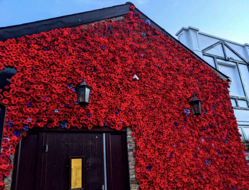 Flowers cover the roof of the building in a stunning display of remembrance (Image: Ellie Brown)