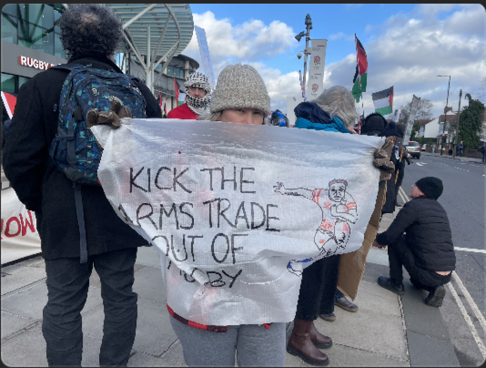 A protester with her sign. (Photo Credit: Heather Nicholls).