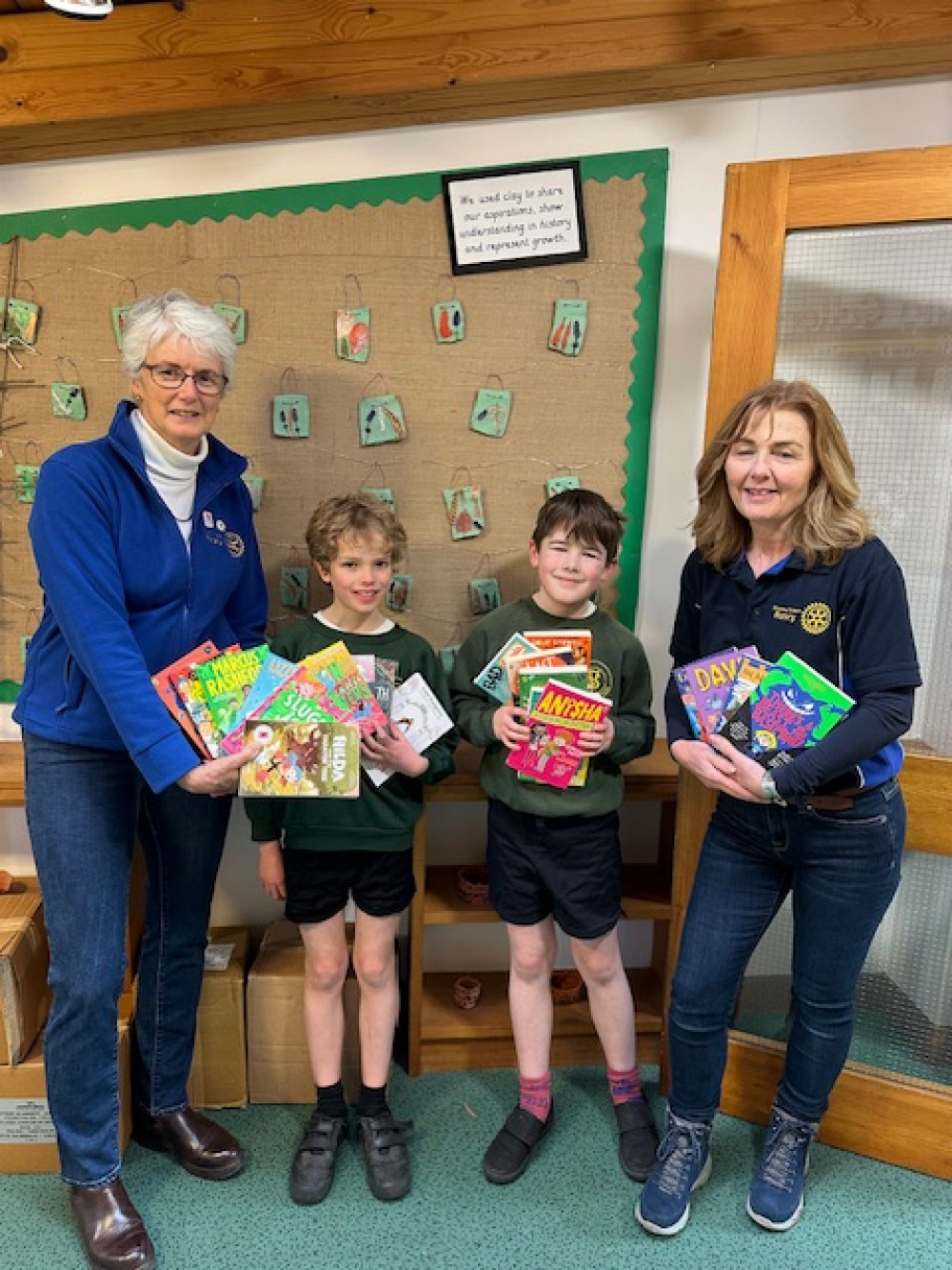 Vallis First School children sharing the new books with Rotary Club members, image Vallis School