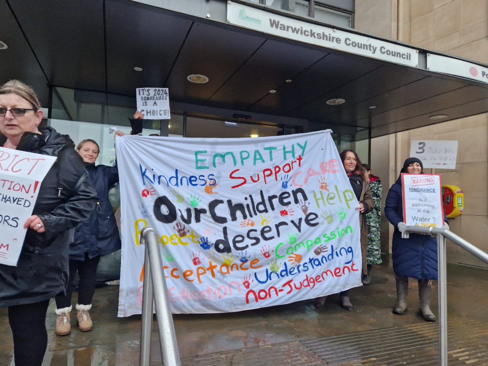 Protesters braved the rain to make their feelings known outside Shire Hall today (image via Elissa Novak)