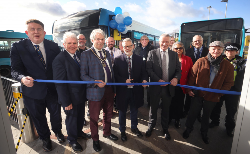 Darren Roe cuts the ribbon surrounded by local dignitaries Darren Roe cuts the ribbon surrounded by local dignitaries