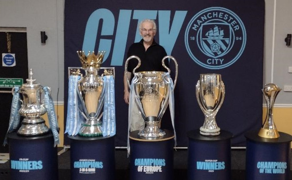 The Thirteen Club's Steve Johnson in front of Manchester City trophies. (Photo: Steve Johnson) 