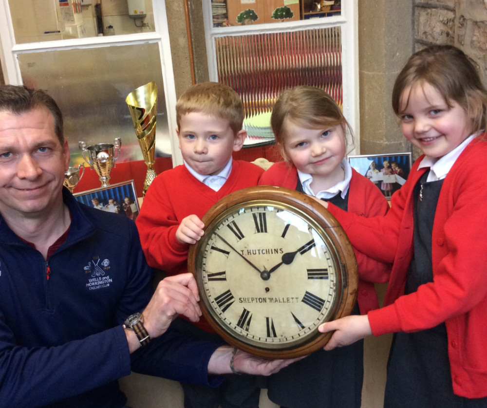 Mike Elderton handing the clock over to the children