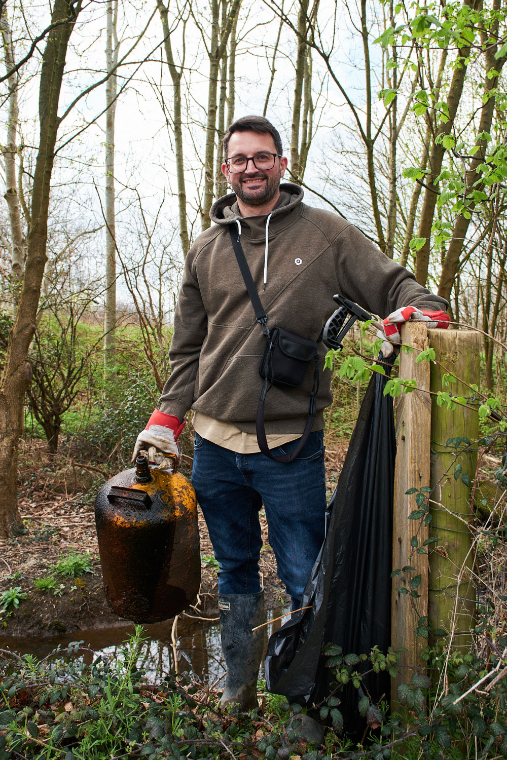 Volunteer Matt Richardson with the catch of the day: an old gas canister left in a small stream (Photo: Oliver Monk)