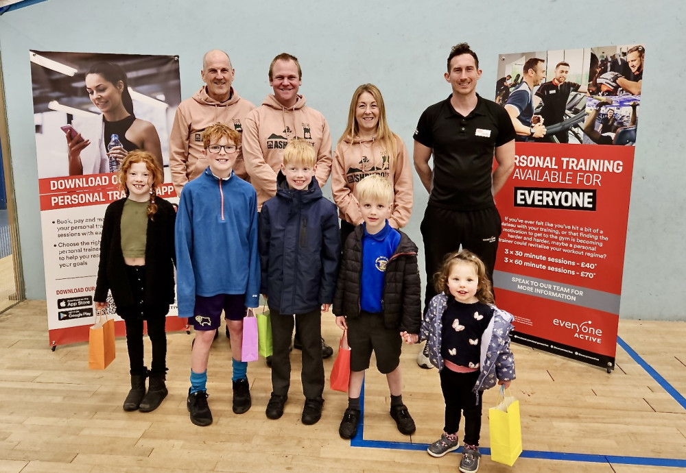 The presentation was made by Chris Nettel (Operations Manager), next to Tamsin Eastaugh (female winner). Also featured are Richard Bebbington (Race Director),  David Askew (male winner) and Paul's grandchildren left to right Sophie, Josh, Ellie, Archer, and Cloe.