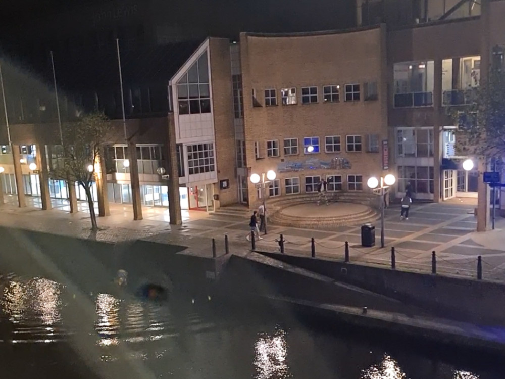 A group of men were seen 'jumping and celebrating' along the river on 13 April. Spectrum the bear can be seen in the bottom-left (Photo: Anonymous via Nub News)