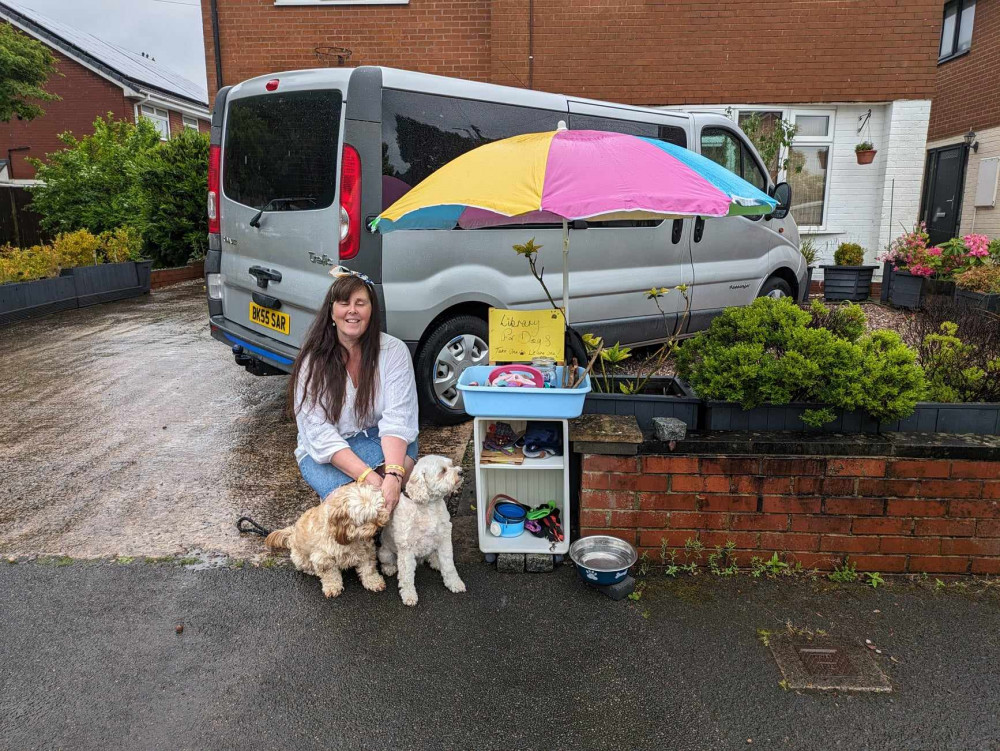 Sarah with her two dogs, Alfie and Molly, next to her dog library. (Photo: Nub News)