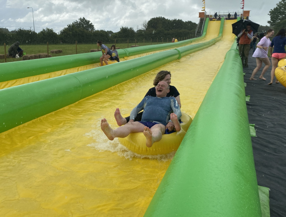 Liberal Democrat leader Ed Davey in a rubber ring on a waterslide with Anna Sabine, Lib Dem hopeful for Frome and East Somerset (Image by John Wimperis)