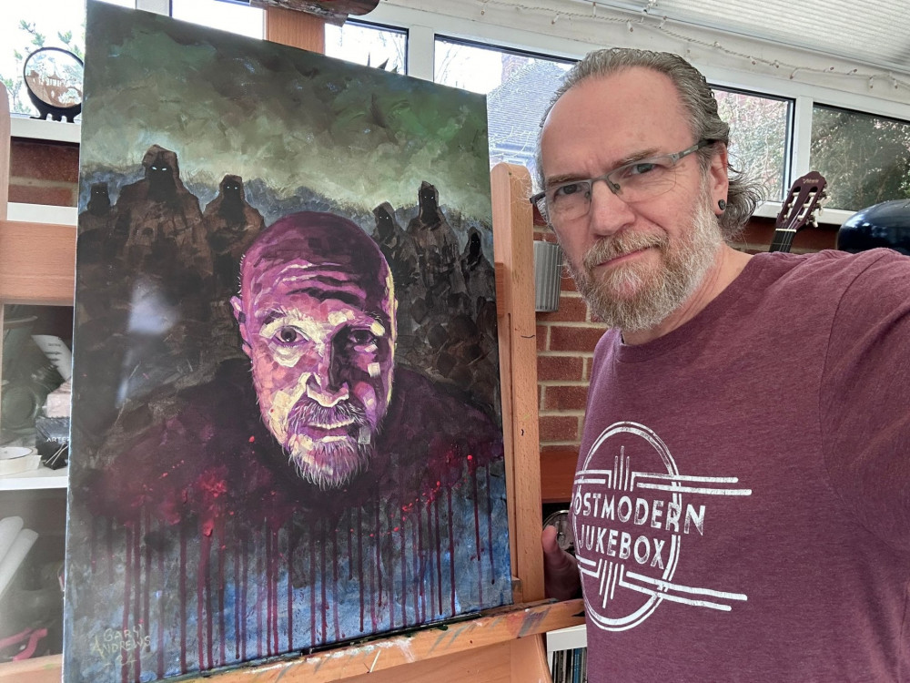 Artist Gary Andrews and the original painting of the Macbeth poster (Submitted) 