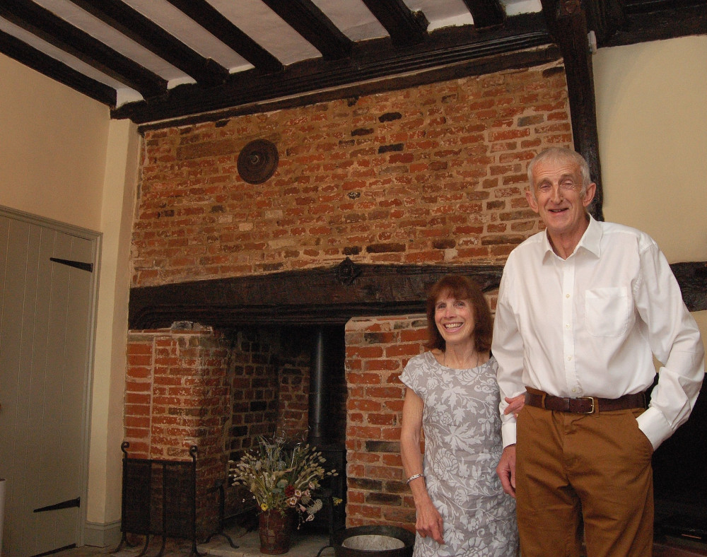 Heather and Nigel Hynam, by their carefully restored inglenook fireplace.