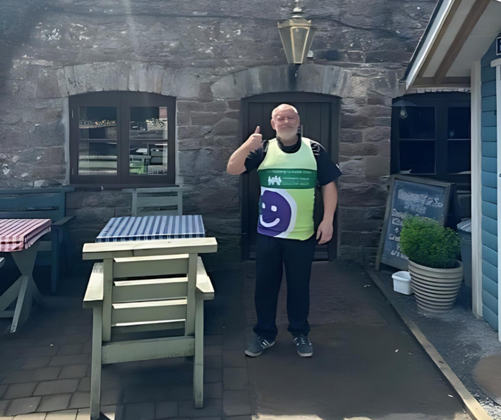 Mark Walton in his CHSW running top outside the Queen Victoria in Priddy (Submitted) 