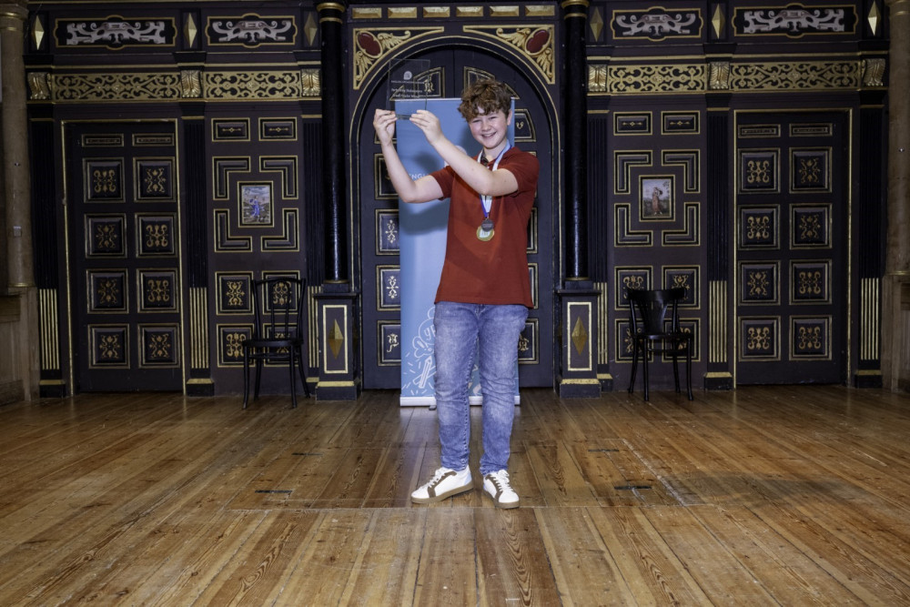 Charlie with his award on stage at the Sam Wanamaker Playhouse. Image credit: Oakham School. Charlie with his award on stage at the Sam Wanamaker Playhouse. Image credit: Oakham School.