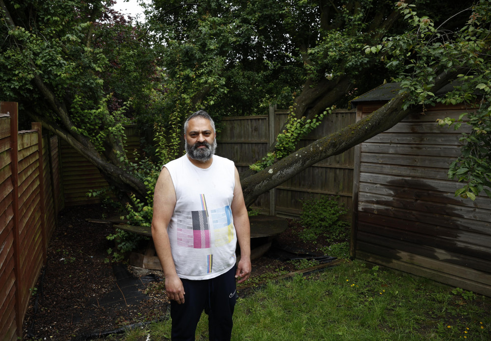 Sohail Khan fears a collapsing tree in his garden could give way at any moment and cause damage to neighbours (credit: Facundo Arrizabalaga/MyLondon).