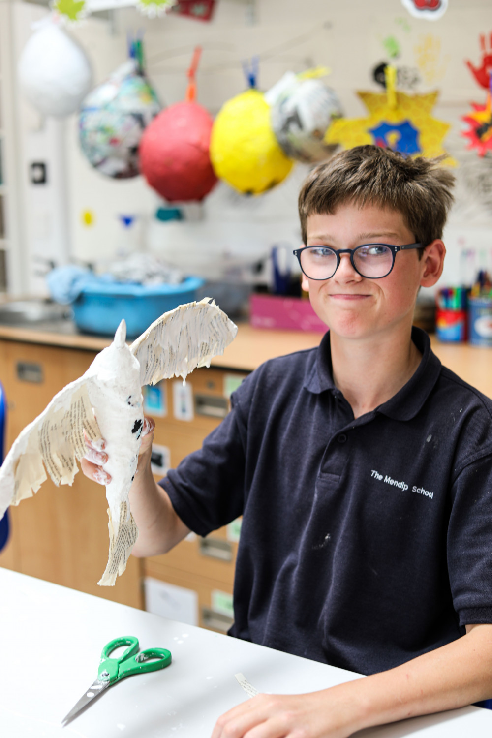 A student at The Mendip School with his bird sculpture in progress