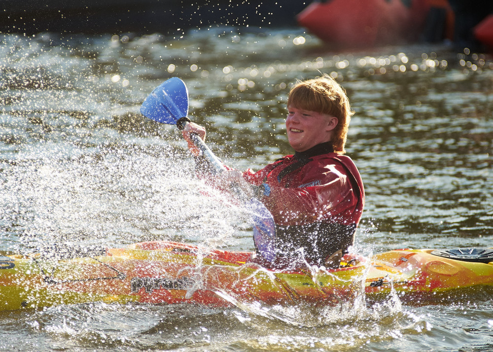 A kayaker gets into a water fight before disembarking. (Photo: Oliver Monk)