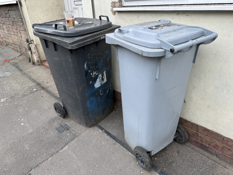 A black bin (left) on Mill Street in Crewe. 