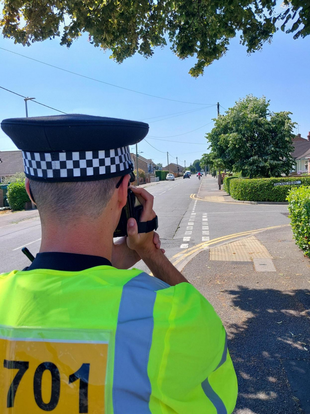 A police officer checks vehicles on Branksome Avenue