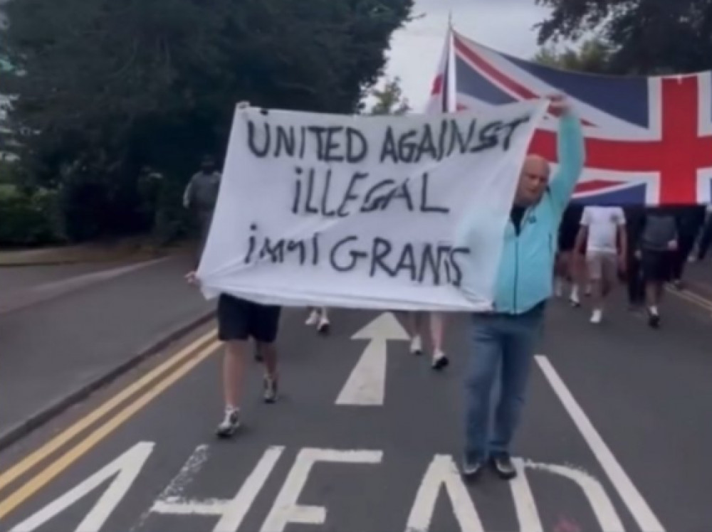 Protesters carrying banners through the streets of Solihull (image via X)