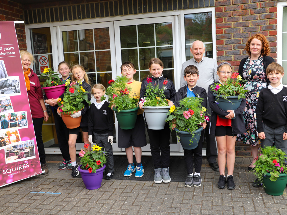 Above from left: Louise Jackson from Squire’s Twickenham Plant Department, Colin Squire OBE., Chairman Emeritus – Squire’s Garden Centres and Miss Rachael Macklearn, Acting Headteacher – Bishop Perrin C of E Primary School, Twickenham, with pupils from the school’s Green Team (credit: Squire's Garden Centres).