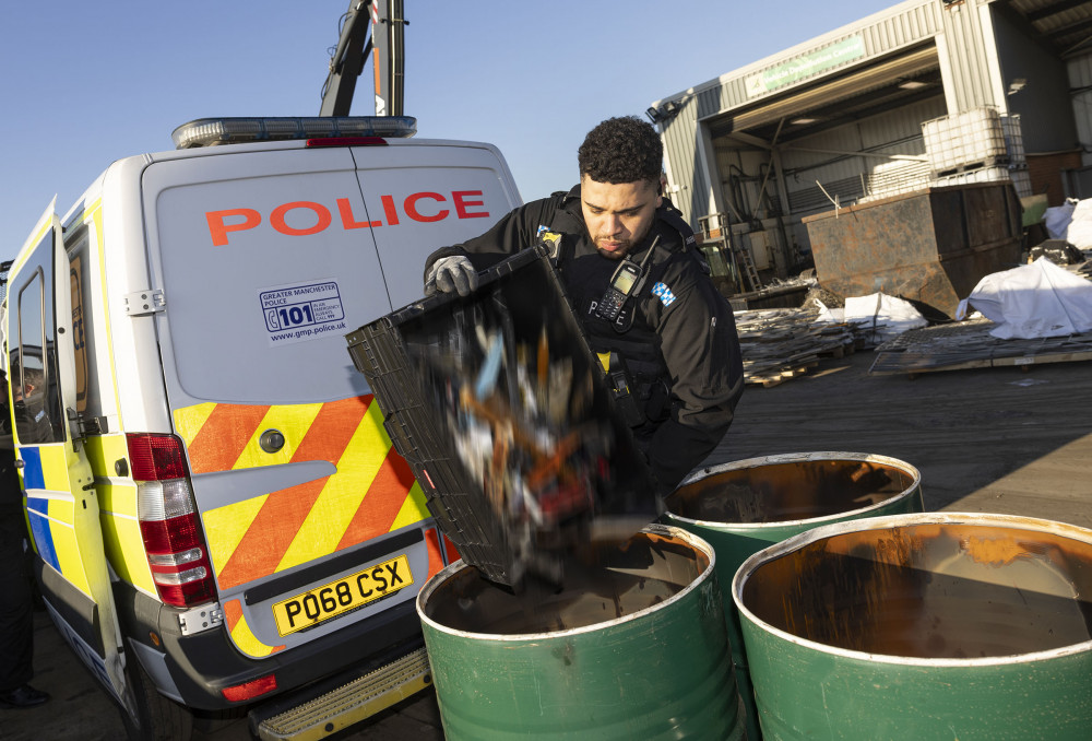 A GMP officer helps to recycle some of the knives which have been dropped off in knife bins (Image - Greater Manchester Police)