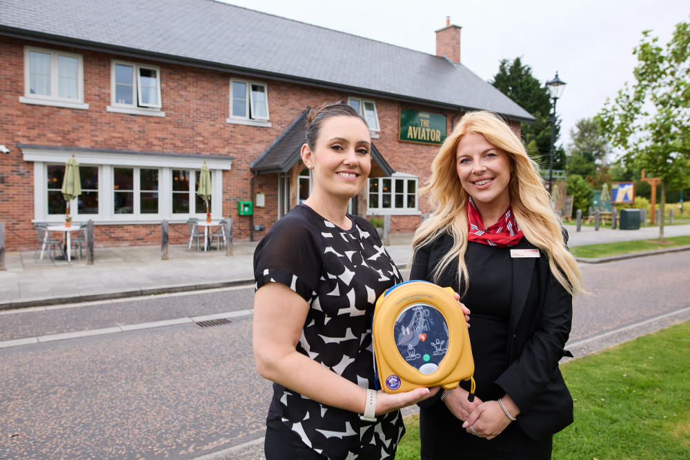 A new life-saving defibrillator has been installed at Woodford Garden Village, outside The Aviator pub (Image - Redrow)