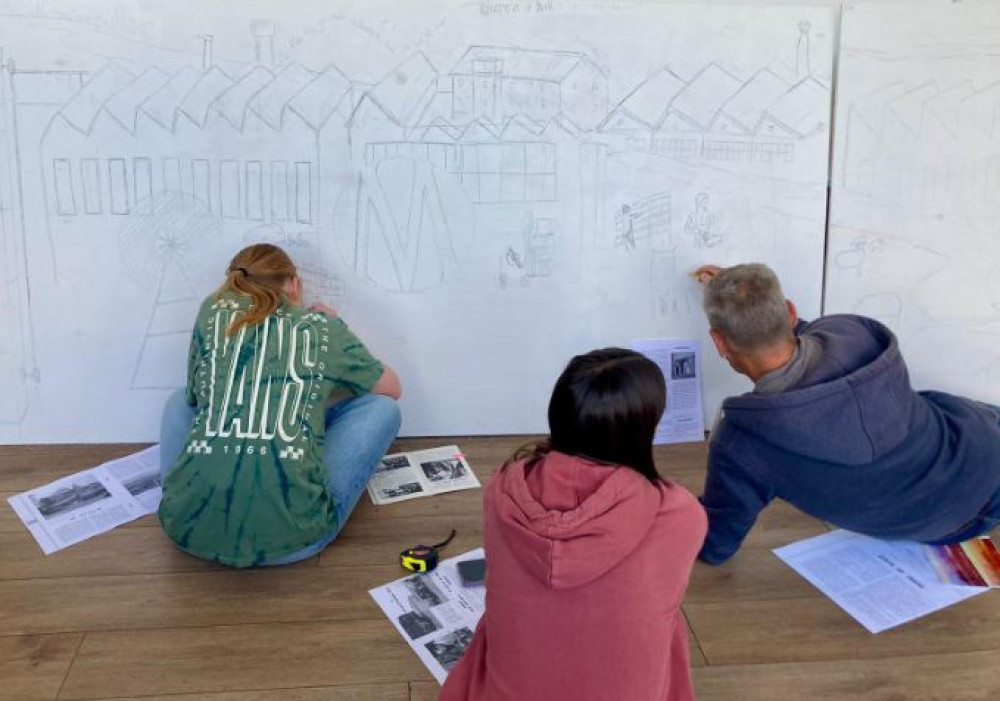 Young volunteers designing the mural which will be painted at FleeceFest (Submitted) 