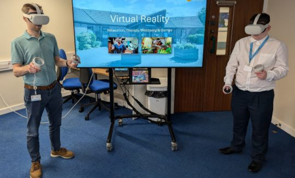 IT staff demonstrate the VR headsets. 